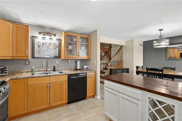 a kitchen with a sink stove and cabinets