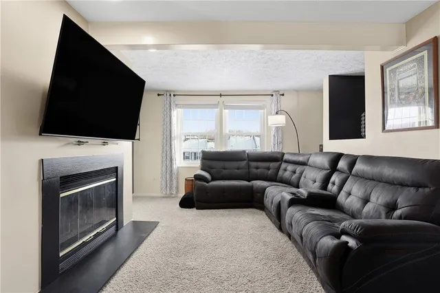 a living room with a fireplace and a flat screen tv