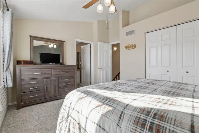 a bathroom with a granite countertop toilet a sink a mirror and shower
