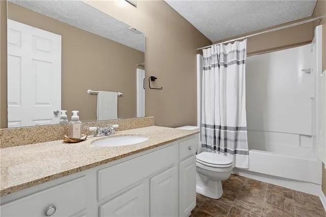 a bedroom with furniture and a flat screen tv