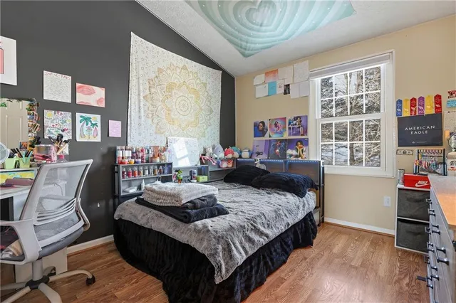 a bedroom with furniture and wooden floor