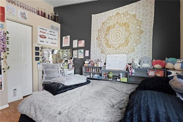 a bedroom with a bed and a dresser