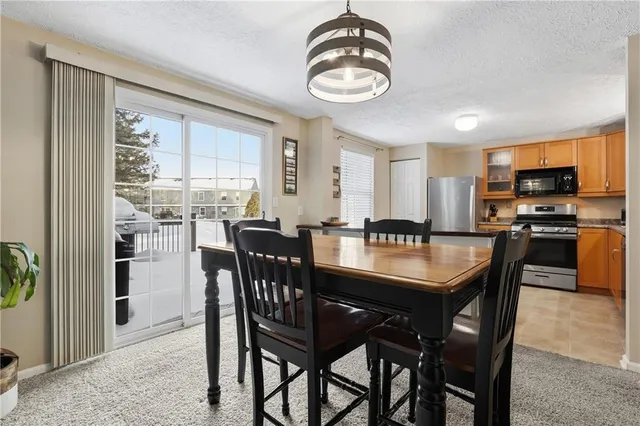 a kitchen with stainless steel appliances kitchen island granite countertop a stove a sink a microwave and a refrigerator