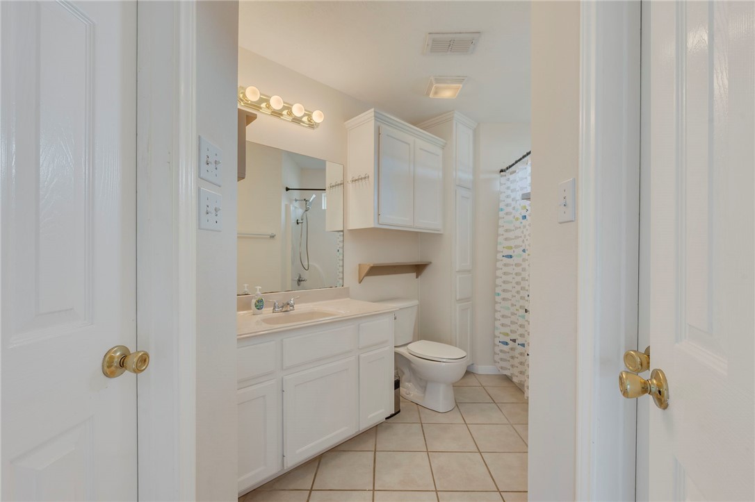 501 Riggs Street Brenham, TX 77833 - Photo 13 of 22 a bathroom with a sink a toilet and shower