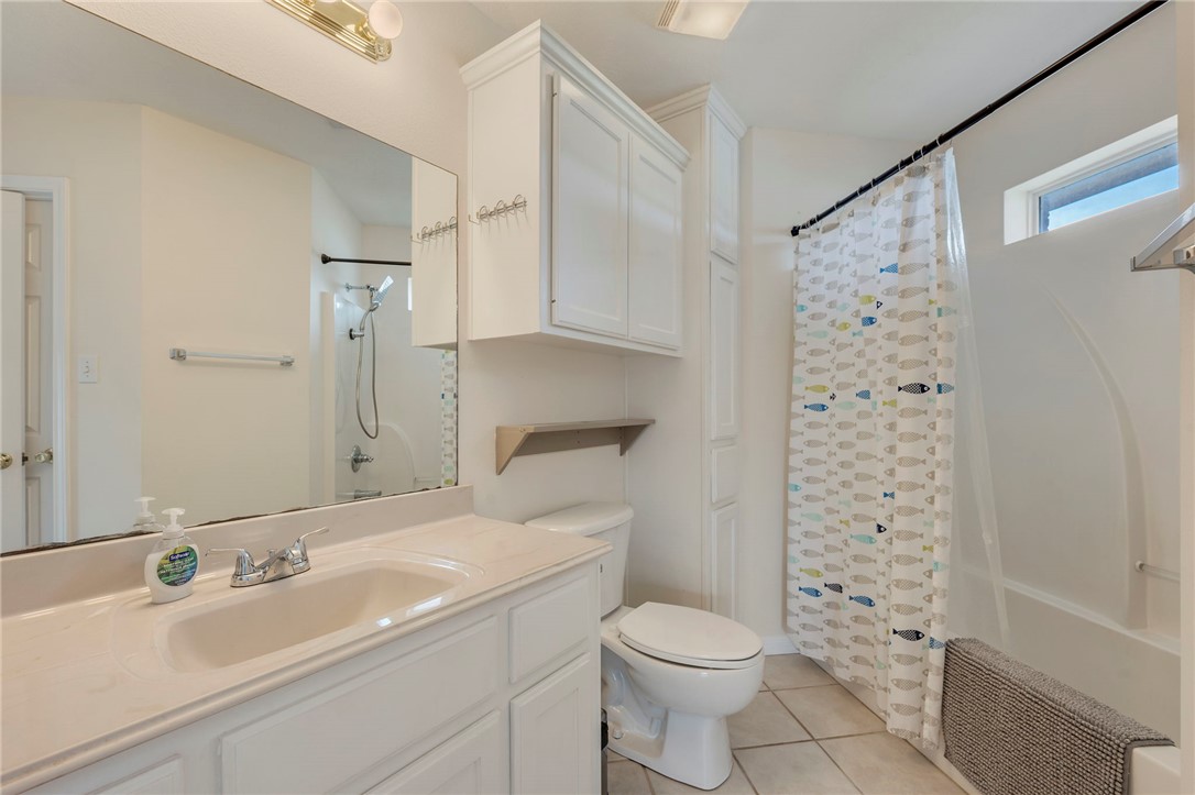 501 Riggs Street Brenham, TX 77833 - Photo 14 of 22 a bathroom with a sink a toilet and shower