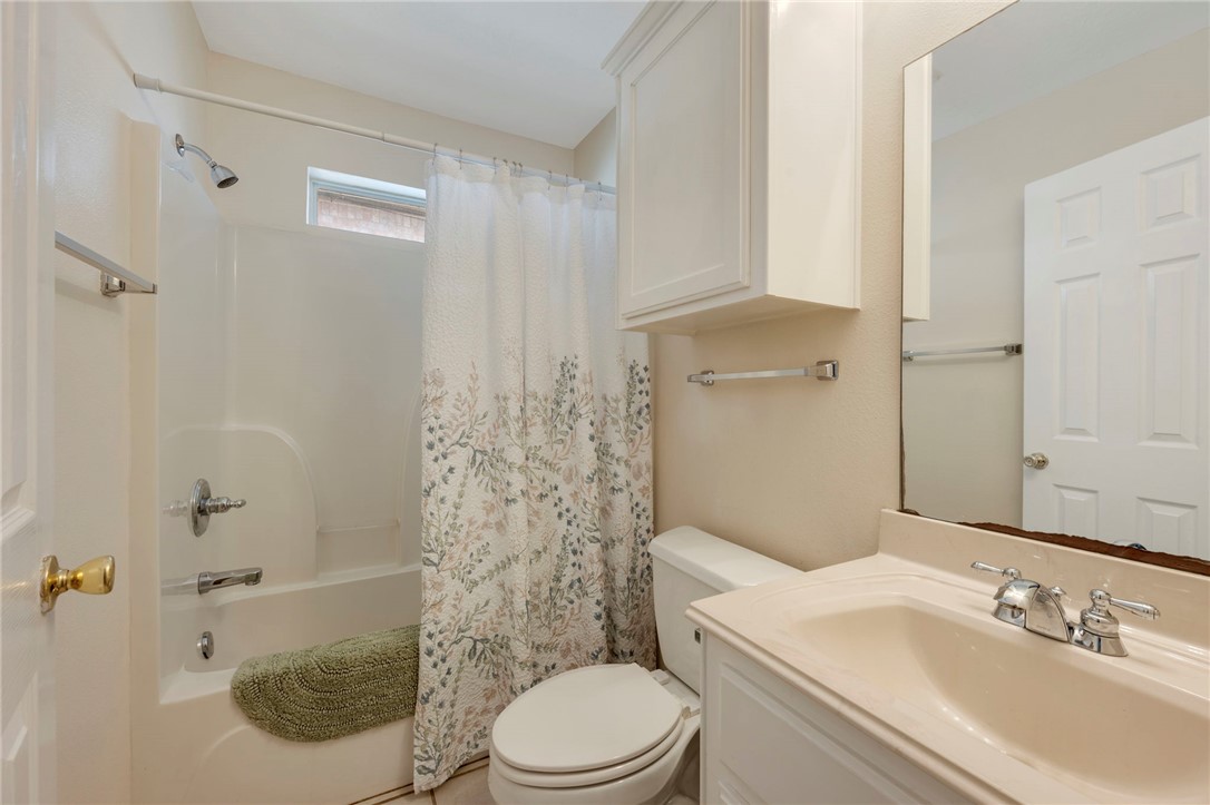 501 Riggs Street Brenham, TX 77833 - Photo 17 of 22 a bathroom with a sink a toilet and shower