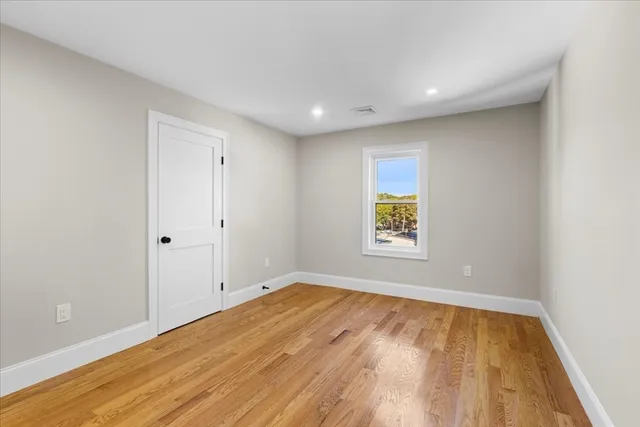 a view of room with window and wooden floor