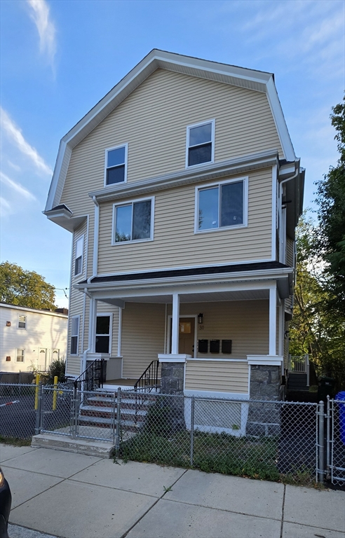 31 Woodale Avenue, Unit 3 Boston, MA 02126 - Photo 18 of 18 a front view of a house with garage