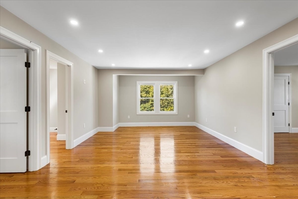 31 Woodale Avenue, Unit 3 Boston, MA 02126 - Photo 6 of 18 a view of empty room with wooden floor and fan