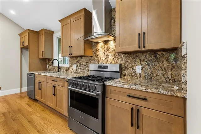 a kitchen with stainless steel appliances granite countertop a stove and a granite counter tops