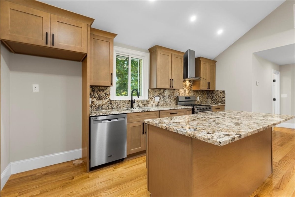 31 Woodale Avenue, Unit 3 Boston, MA 02126 - Photo 9 of 18 a kitchen with stainless steel appliances granite countertop a sink stove and refrigerator