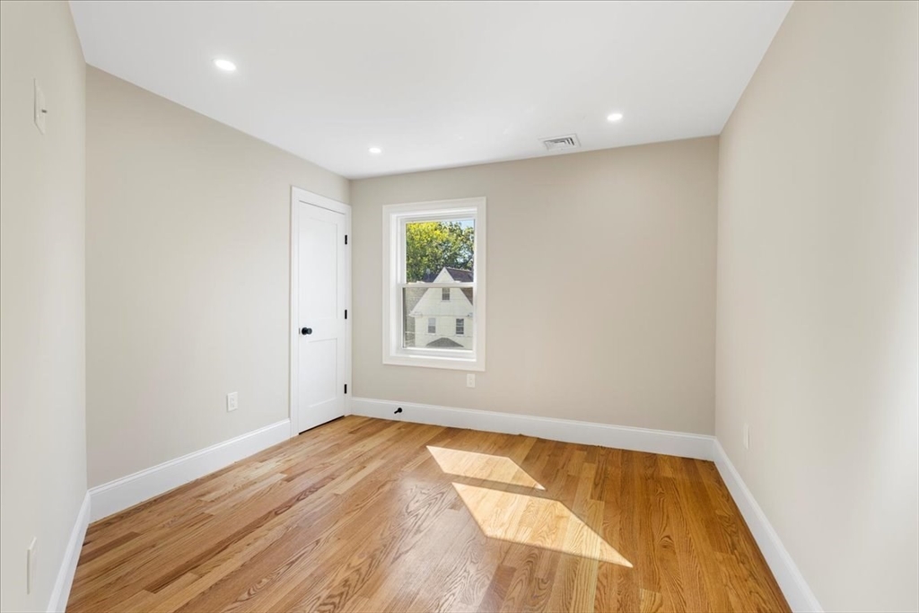 31 Woodale Avenue, Unit 3 Boston, MA 02126 - Photo 10 of 18 a view of room with window and wooden floor