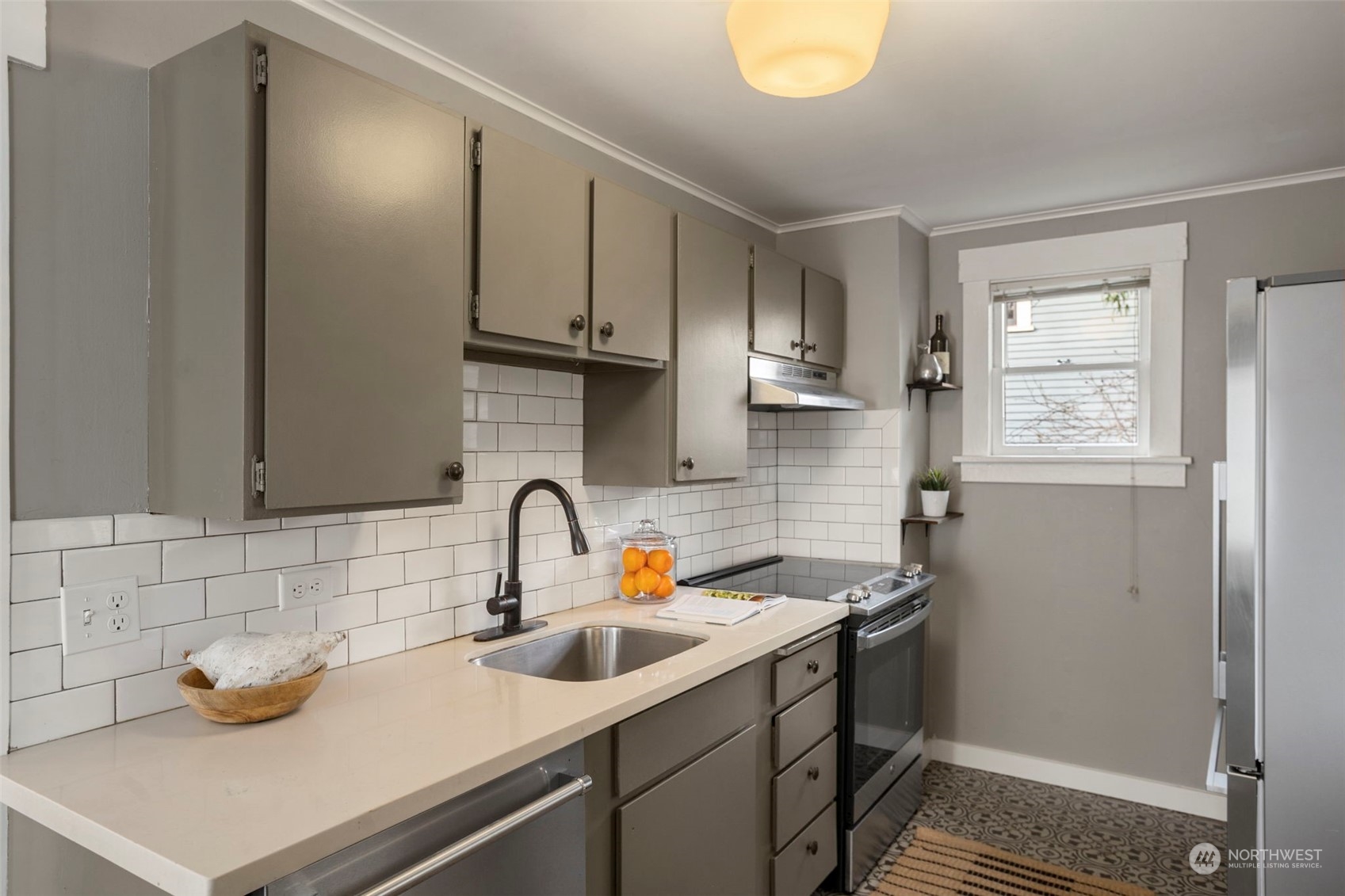 4510 2nd Avenue Northeast Seattle, WA 98105 - Photo 11 of 23 a kitchen with a sink and cabinets