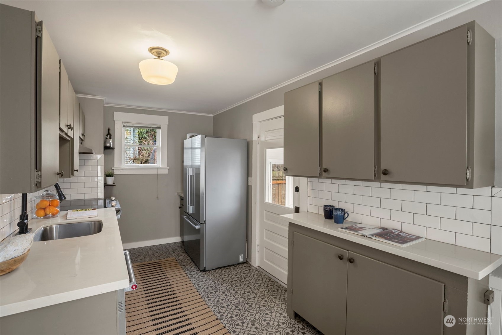 4510 2nd Avenue Northeast Seattle, WA 98105 - Photo 10 of 23 a kitchen with stainless steel appliances granite countertop a refrigerator and a sink