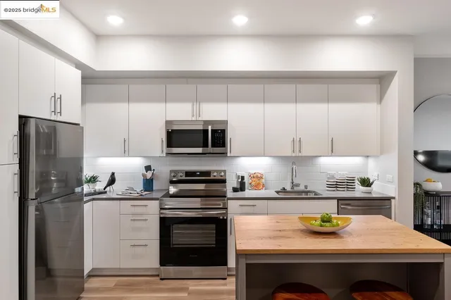 a kitchen with a stove a sink and a refrigerator