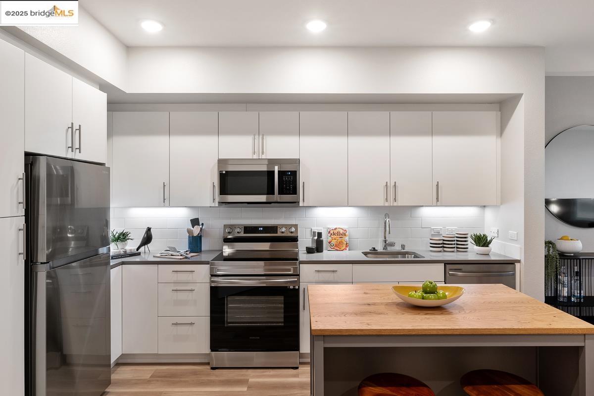260 Brooklyn Basin Way, Unit 540 Oakland, CA 94606 - Photo 12 of 43 a kitchen with a sink a stove and refrigerator