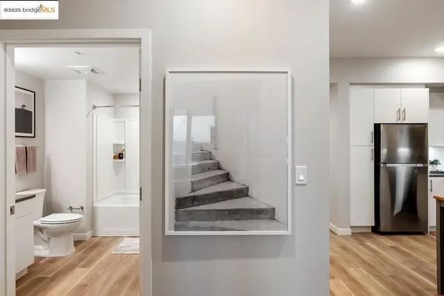a kitchen with a sink a microwave a refrigerator and cabinets