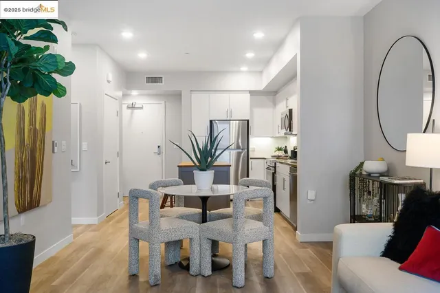 a view of a dining room with furniture and a potted plant