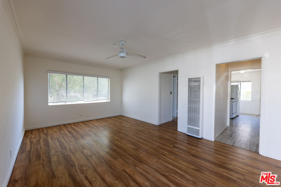 4119 Marlton Avenue, Unit 1 Los Angeles, CA 90008 - Photo 4 of 13 an empty room with wooden floor cabinet and windows