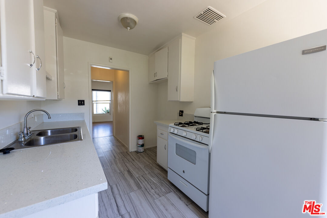 4119 Marlton Avenue, Unit 1 Los Angeles, CA 90008 - Photo 8 of 13 a kitchen with stainless steel appliances granite countertop a sink stove and refrigerator