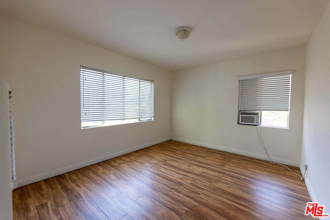 4119 Marlton Avenue, Unit 1 Los Angeles, CA 90008 - Photo 10 of 13 an empty room with wooden floor and windows