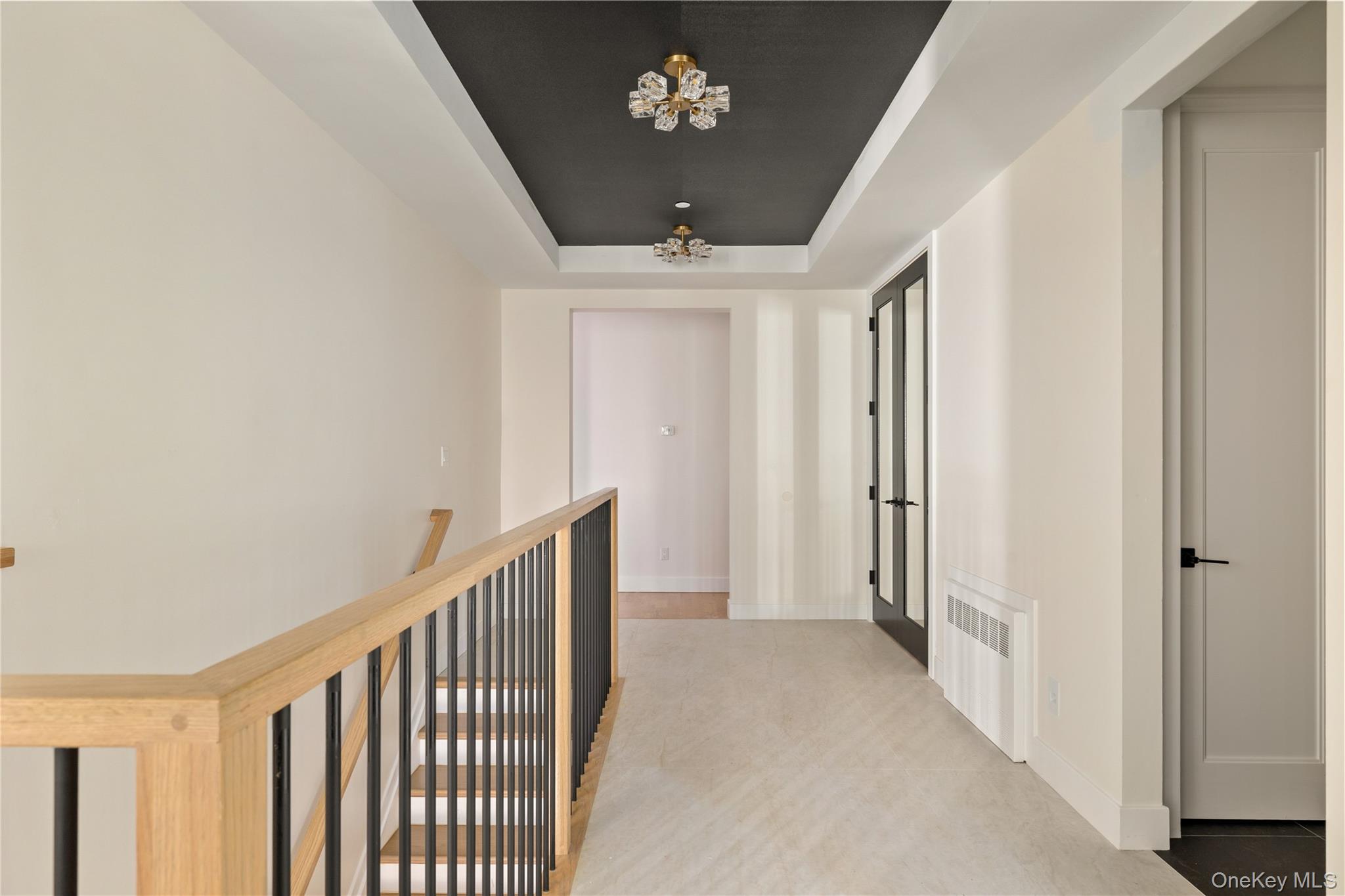 3 Valley Way, Unit 320 Spring Valley, NY 10977 - Photo 19 of 41 Hallway with a raised ceiling, a chandelier, and radiator