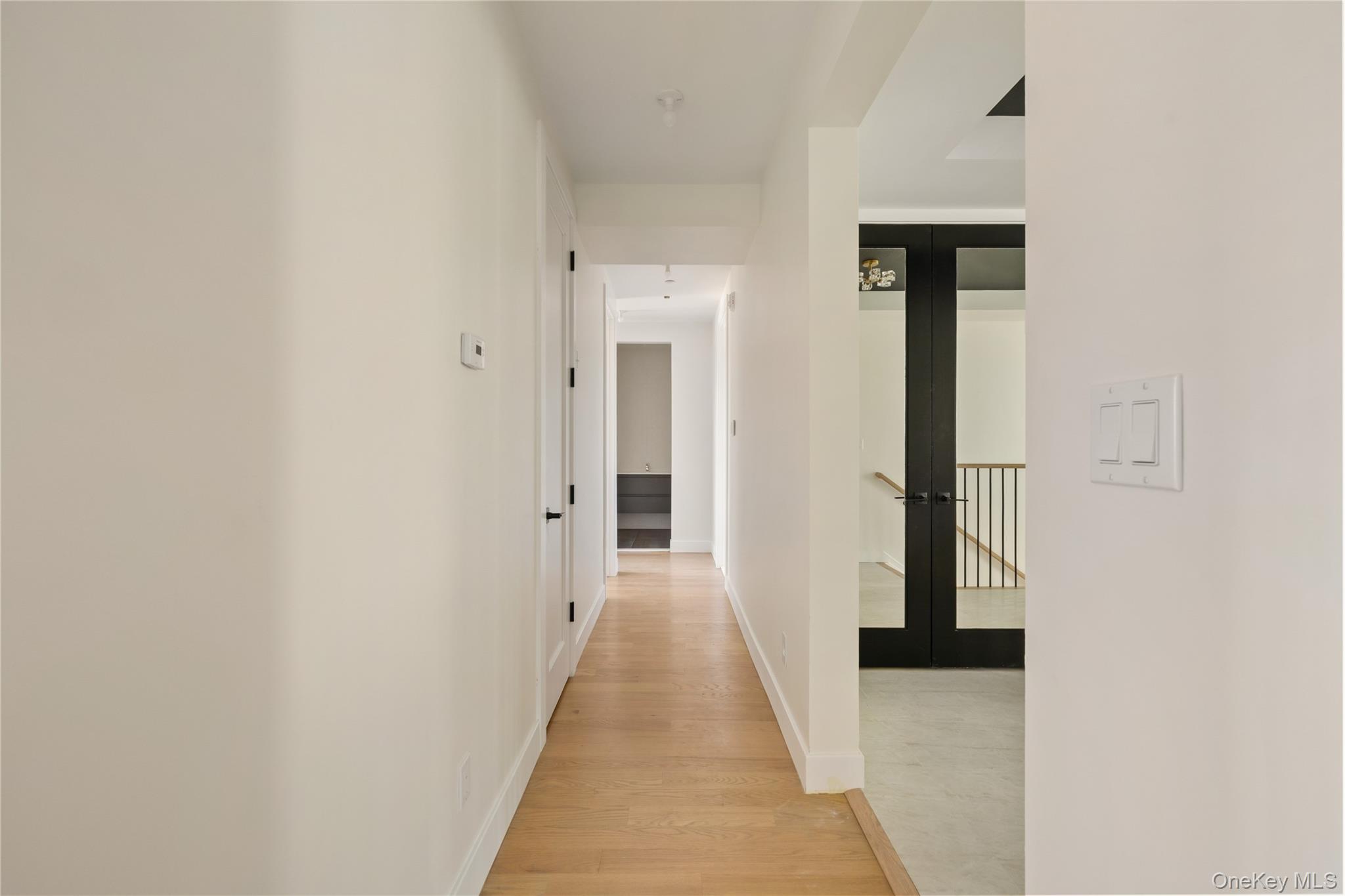 3 Valley Way, Unit 320 Spring Valley, NY 10977 - Photo 23 of 41 Hallway featuring light wood-type flooring and french doors