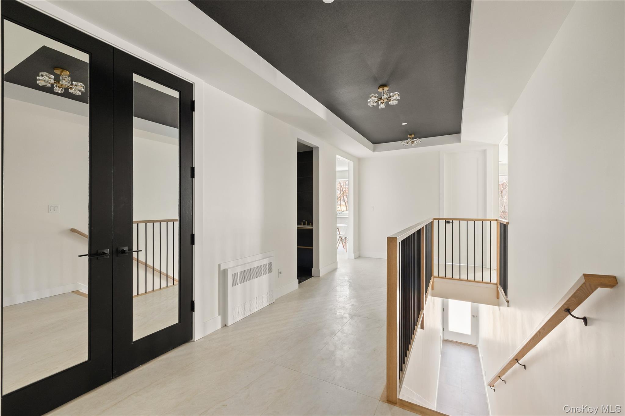 3 Valley Way, Unit 320 Spring Valley, NY 10977 - Photo 8 of 41 Hallway featuring a tray ceiling, french doors, radiator heating unit, and an upstairs landing