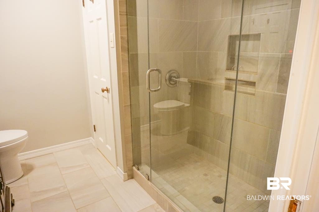 255 Suffolk Road Mobile, AL 36608 - Photo 17 of 29 Bathroom with a shower stall and light tile patterned floors