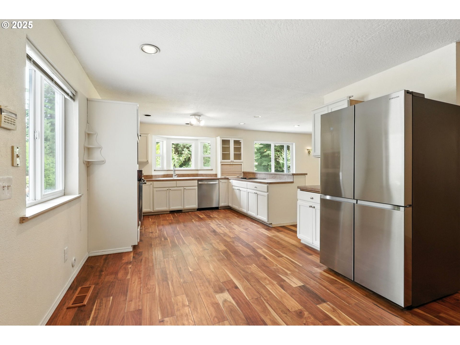 116 Noble Road Winlock, WA 98596 - Photo 13 of 48 a kitchen with refrigerator cabinets and wooden floor