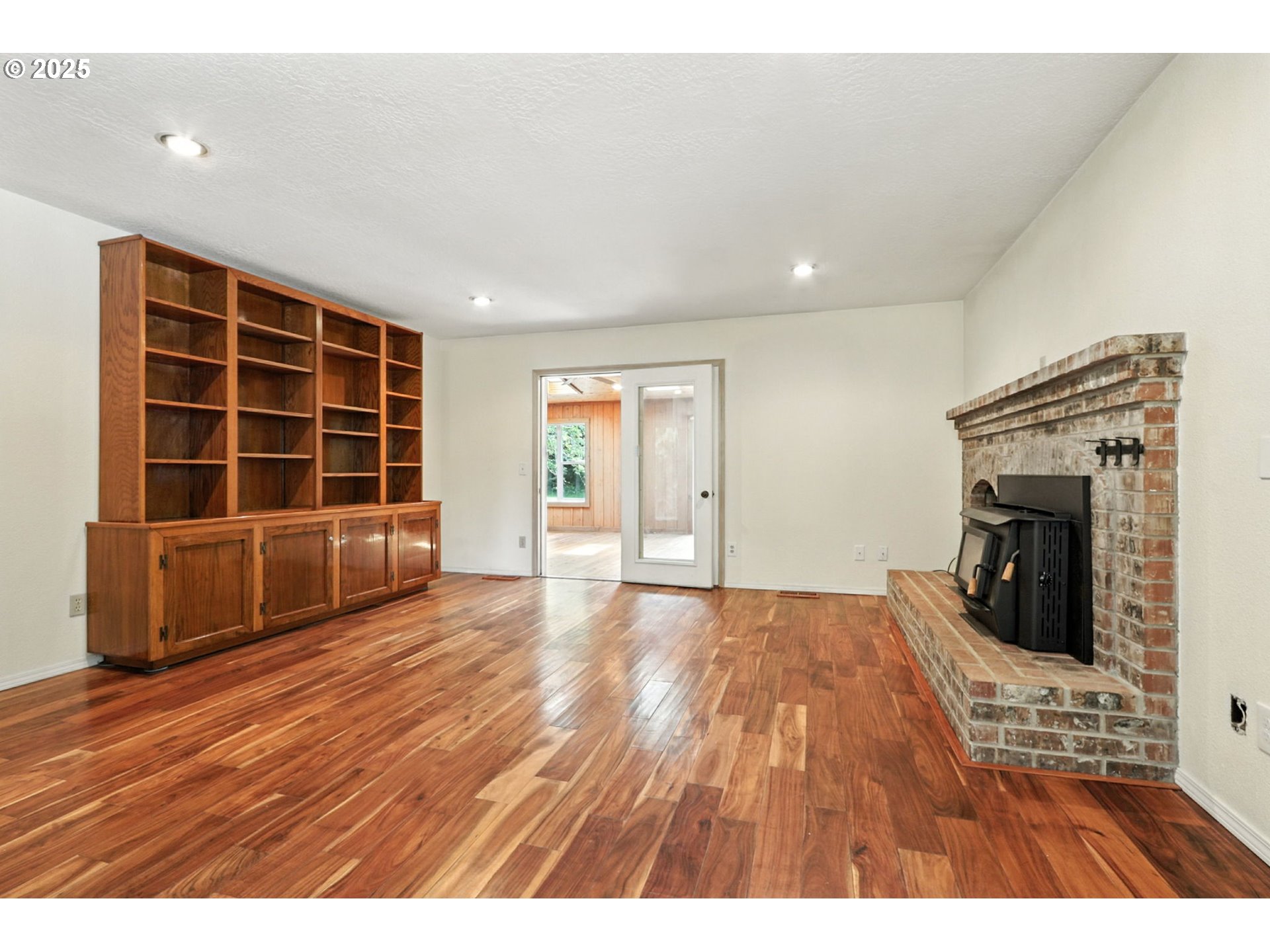 116 Noble Road Winlock, WA 98596 - Photo 14 of 48 wooden floor in an empty room with a fireplace