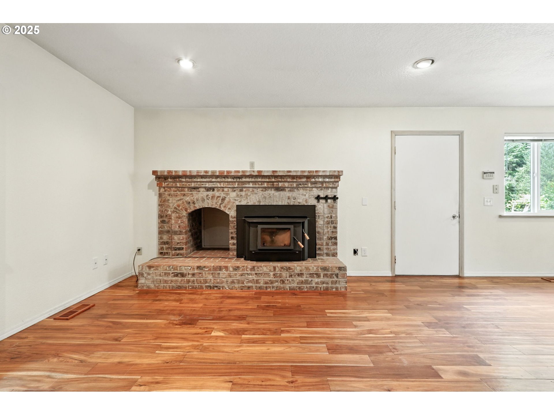 116 Noble Road Winlock, WA 98596 - Photo 15 of 48 a view of empty room with wooden floor and fireplace