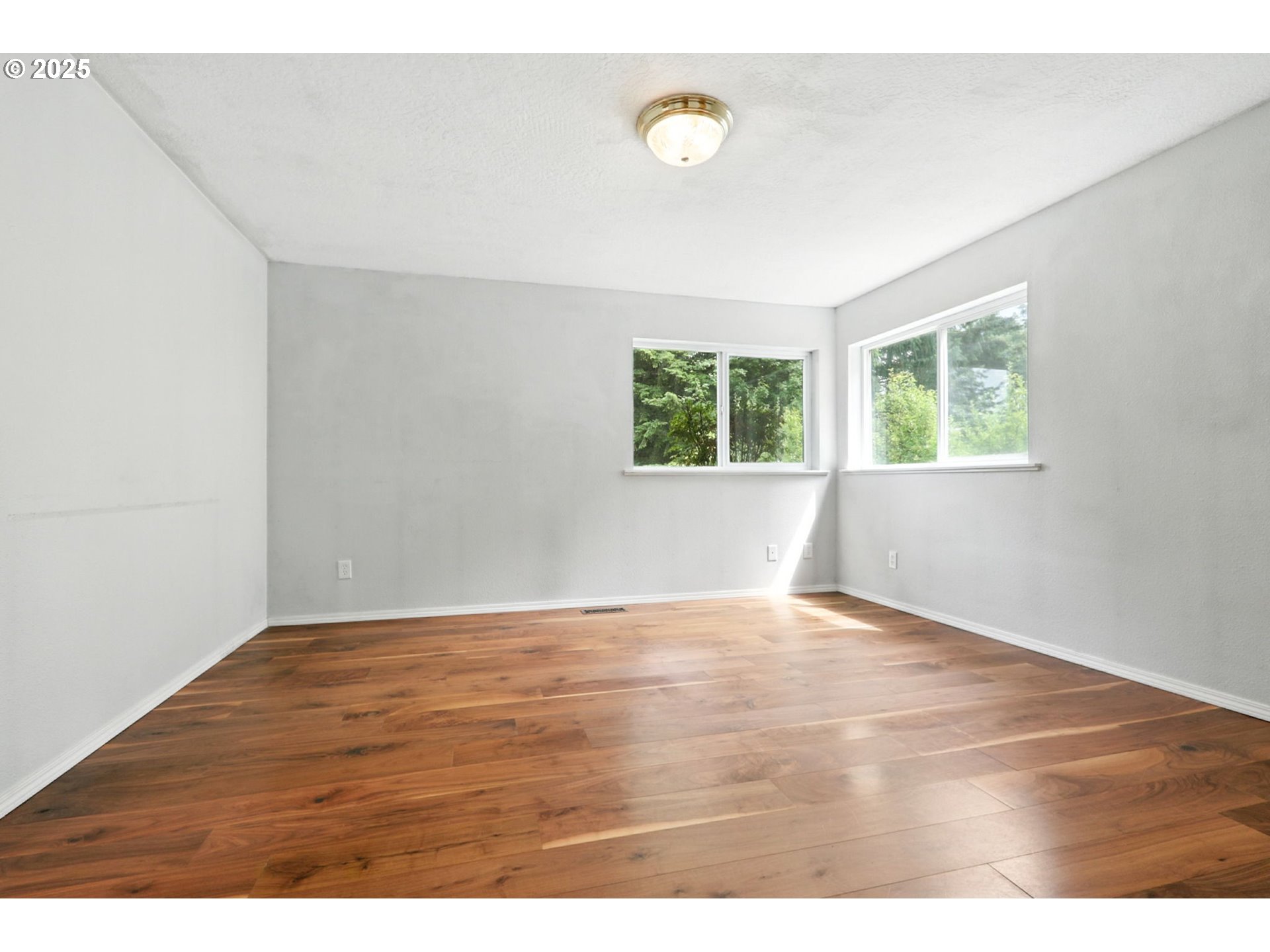 116 Noble Road Winlock, WA 98596 - Photo 21 of 48 a view of an empty room with wooden floor and a window