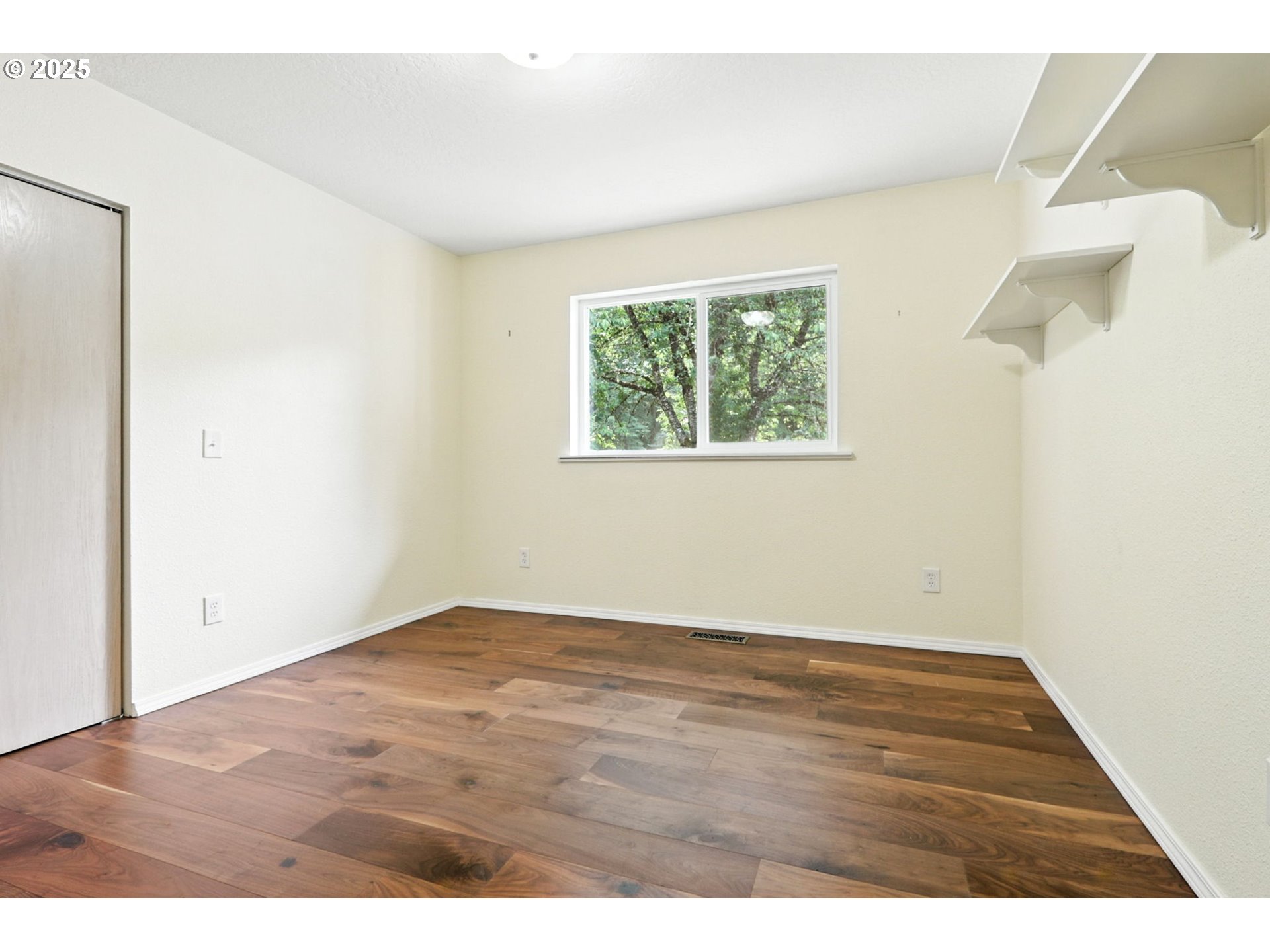 116 Noble Road Winlock, WA 98596 - Photo 29 of 48 a view of an empty room with wooden floor and a window