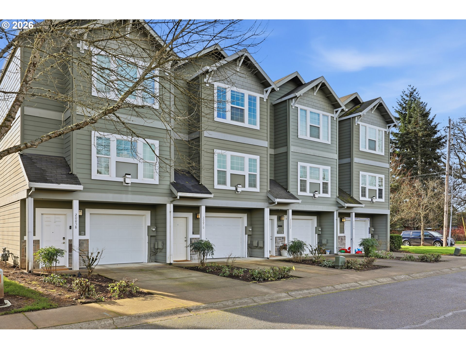 20070 Southwest Cedar Grove Lane Beaverton, OR 97003 - Photo 2 of 19 a front view of a residential apartment building with a yard
