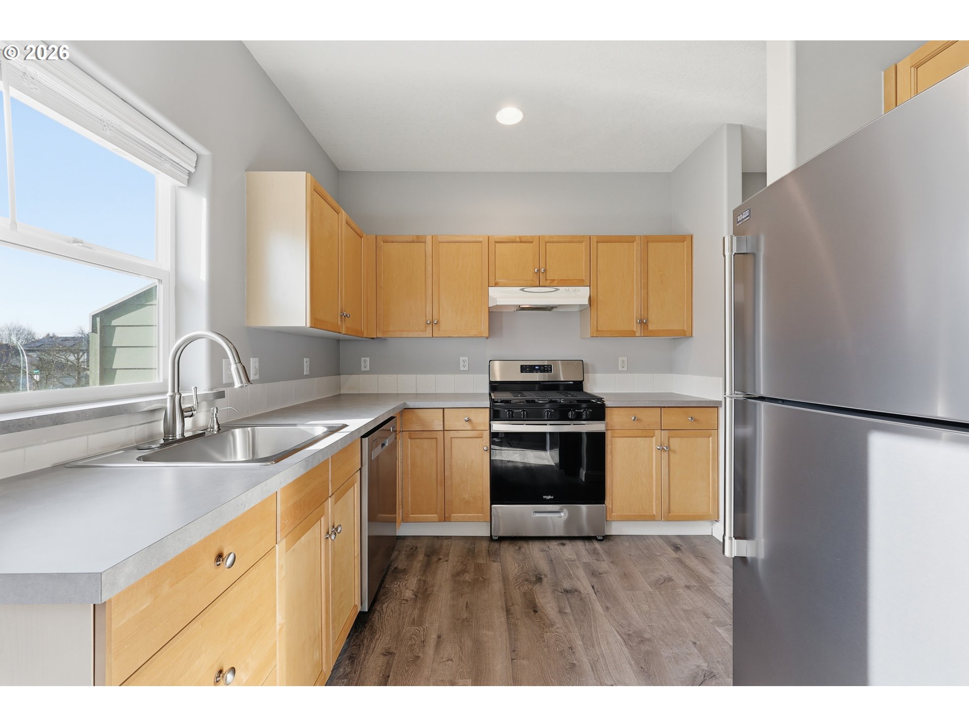20070 Southwest Cedar Grove Lane Beaverton, OR 97003 - Photo 8 of 19 a kitchen with stainless steel appliances granite countertop a refrigerator a sink and a stove