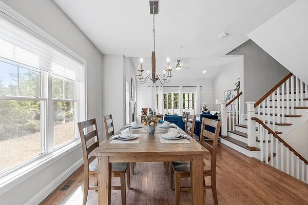 a view of a dining room with furniture window and wooden floor