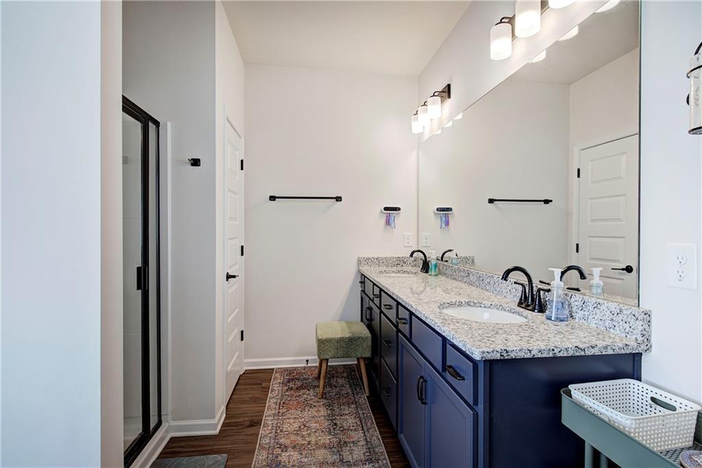 402 Perth Drive Cartersville, GA 30121 - Photo 13 of 31 a bathroom with a granite countertop sink a mirror and a vanity