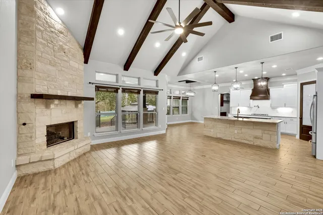 a view of kitchen and living room with wooden floor