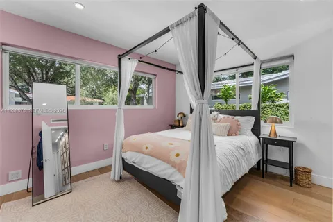 a bed room with a bed and a window