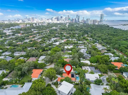 an aerial view of a house with a garden and trees