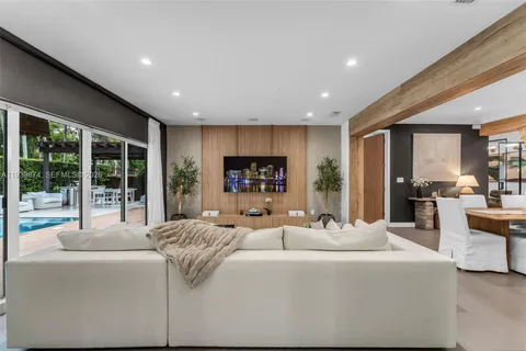 a living room with fireplace furniture and a large window