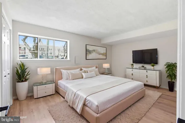 a bedroom with a bed and a flat screen tv