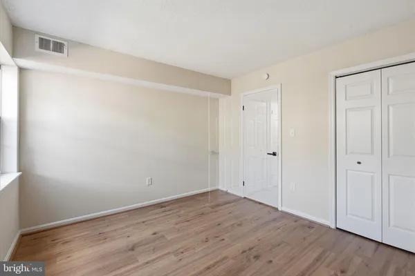 a view of a house with a small yard and wooden fence