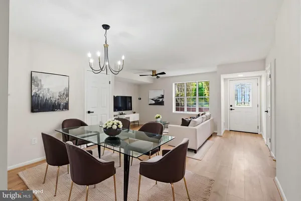 a living room with furniture a window and a chandelier