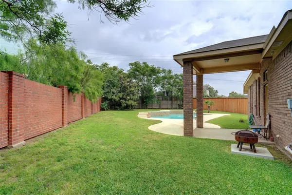a backyard of a house with table and chairs