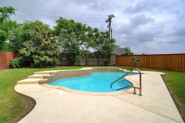 a view of a swimming pool with a patio