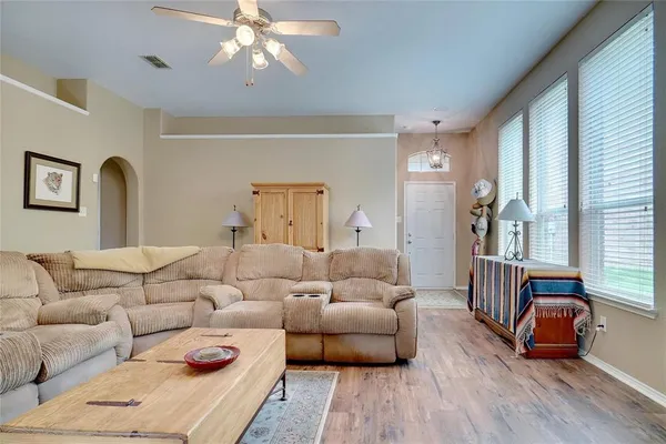 a living room with furniture and wooden floor