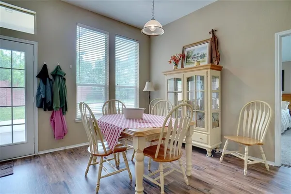 a view of a dining room with furniture window and wooden floor