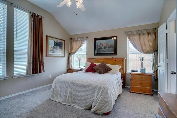 a bedroom with bed and window